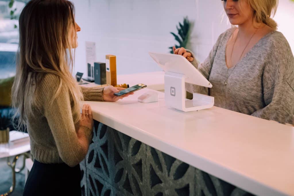 a woman being checked out at a kiosk